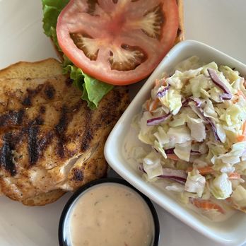 Dry Dock Waterfront Grill - Blackened red snapper sandwich with Cole slaw and spicy chili sauce - Seafood Near Me - Longboat Key, Florida Dry Dock Waterfront Grill - Blackened red snapper sandwich with Cole slaw and spicy chili sauce - Seafood Near Me - Longboat Key, Florida