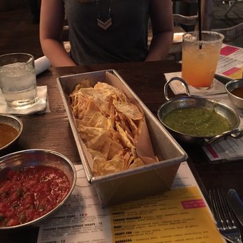 MEX - Baked chips with four salsas - ghost pepper margarita in the background! - Mexican Near Me - Bloomfield Hills, Michigan MEX - Baked chips with four salsas - ghost pepper margarita in the background! - Mexican Near Me - Bloomfield Hills, Michigan