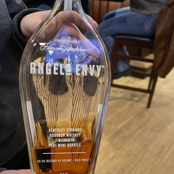 Best Cigar Pub - a person holding a bottle of alcohol - Cocktail Bars Near Me - Drums, Pennsylvania