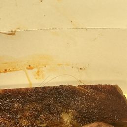 Was enjoying my ribs and saw this piece of hair peaking out at me from the corner, it was WRAPPED around this rib