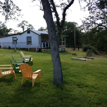 Dakaro Cellars - a lawn with lawn chairs and trees - Wineries Near Me - Whitmore, California