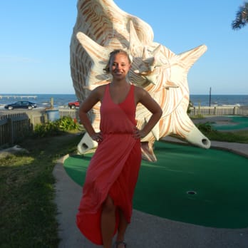 Magic Carpet Golf - Posing by the massive conch shell - Amusement Parks Near Me - Galveston, Texas Magic Carpet Golf - Posing by the massive conch shell - Amusement Parks Near Me - Galveston, Texas