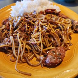 a plate of noodles and meat a plate of noodles and meat