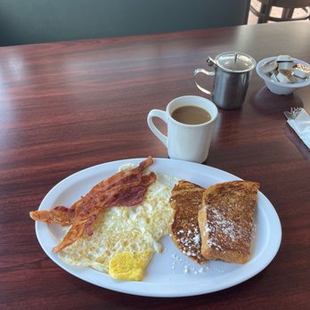 Toasted Cafe - French toast, two eggs cooked (hard) and two strips bacon (crispy). My food needs to be cooked thoroughly. PERFECT - New American Near Me - Margate, Florida