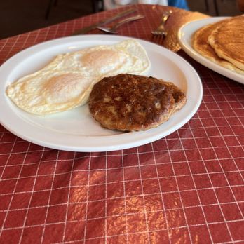The Robin's Nest - Eggs over easy and two sausage patties that came with 2 large pancakes. - New American Near Me - Hayward, Wisconsin The Robin's Nest - Eggs over easy and two sausage patties that came with 2 large pancakes. - New American Near Me - Hayward, Wisconsin