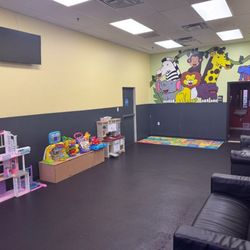 Powerhouse Gym Linden - The photo shows the kids' play area at our gym in Linden with onsite childcare. The room includes cheerful animal wall art, p...