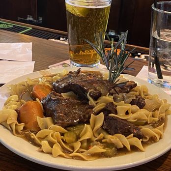 Scratch Public House - Pot Roast Tuesday - juicy pot roast in a savory sauce on a bed of egg noodles with carrots, onions, and celery. - Burgers Near Me - Forest Park, Illinois Scratch Public House - Pot Roast Tuesday - juicy pot roast in a savory sauce on a bed of egg noodles with carrots, onions, and celery. - Burgers Near Me - Forest Park, Illinois