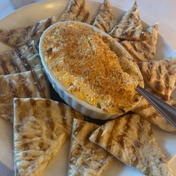 Abby Park - Lobster Dip - A round plate holds baked triangular appetizers surrounding a cheese dip topped with breadcrumbs, served at a restaurant. - New American Near Me - Milton, Massachusetts