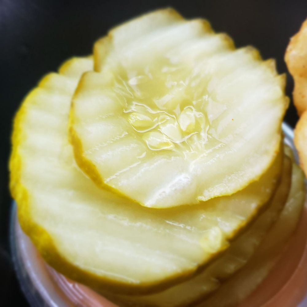 Dave's Hot Chicken - a closeup of a sliced pickle - Halal Near Me - Wauwatosa, Wisconsin Dave's Hot Chicken - a closeup of a sliced pickle - Halal Near Me - Wauwatosa, Wisconsin
