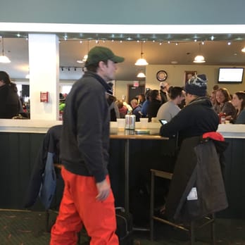 Long Trail Pub - a man walking past a bar - Pubs Near Me - Killington, Vermont Long Trail Pub - a man walking past a bar - Pubs Near Me - Killington, Vermont