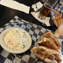Boulder Tap House - The pulled pork sandwich with coleslaw. Topped with perfect Onion Rings