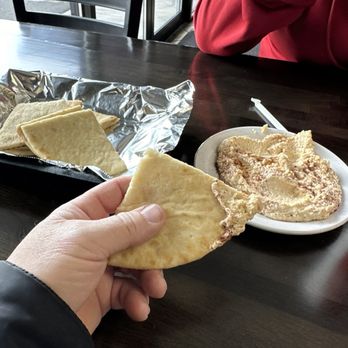 Gyro House - a person holding a piece of bread - Mediterranean Near Me - Yakima, Washington Gyro House - a person holding a piece of bread - Mediterranean Near Me - Yakima, Washington