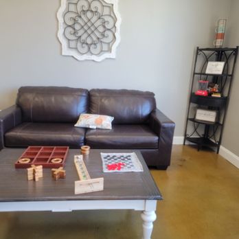 Daily Grind - a living room with a leather couch and coffee table - Coffee & Tea Near Me - Kinston, North Carolina Daily Grind - a living room with a leather couch and coffee table - Coffee & Tea Near Me - Kinston, North Carolina