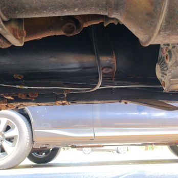 Hunter's Auto Service - Brake line dangling  under vehicle supported by parking brake cable & other objects - Auto Repair Near Me - Delavan, Wisconsin