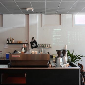 Revolutions Coffee - a woman standing in a coffee shop - Coffee & Tea Near Me - Seattle, Washington