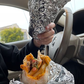 El Burrito Express - a person holding a burrito - Mexican Near Me - San Francisco, California El Burrito Express - a person holding a burrito - Mexican Near Me - San Francisco, California