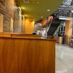 a wooden counter and stairs a wooden counter and stairs