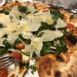 Parmigiano pizza, with cherry tomatoes, wild mushrooms, arugula, and mozzarella.