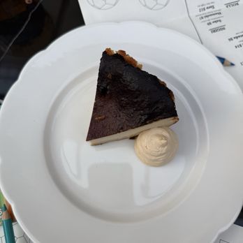 Bar Colette - Basque cheesecake along with coloring page and pencils - Cocktail Bars Near Me - Dallas, Texas