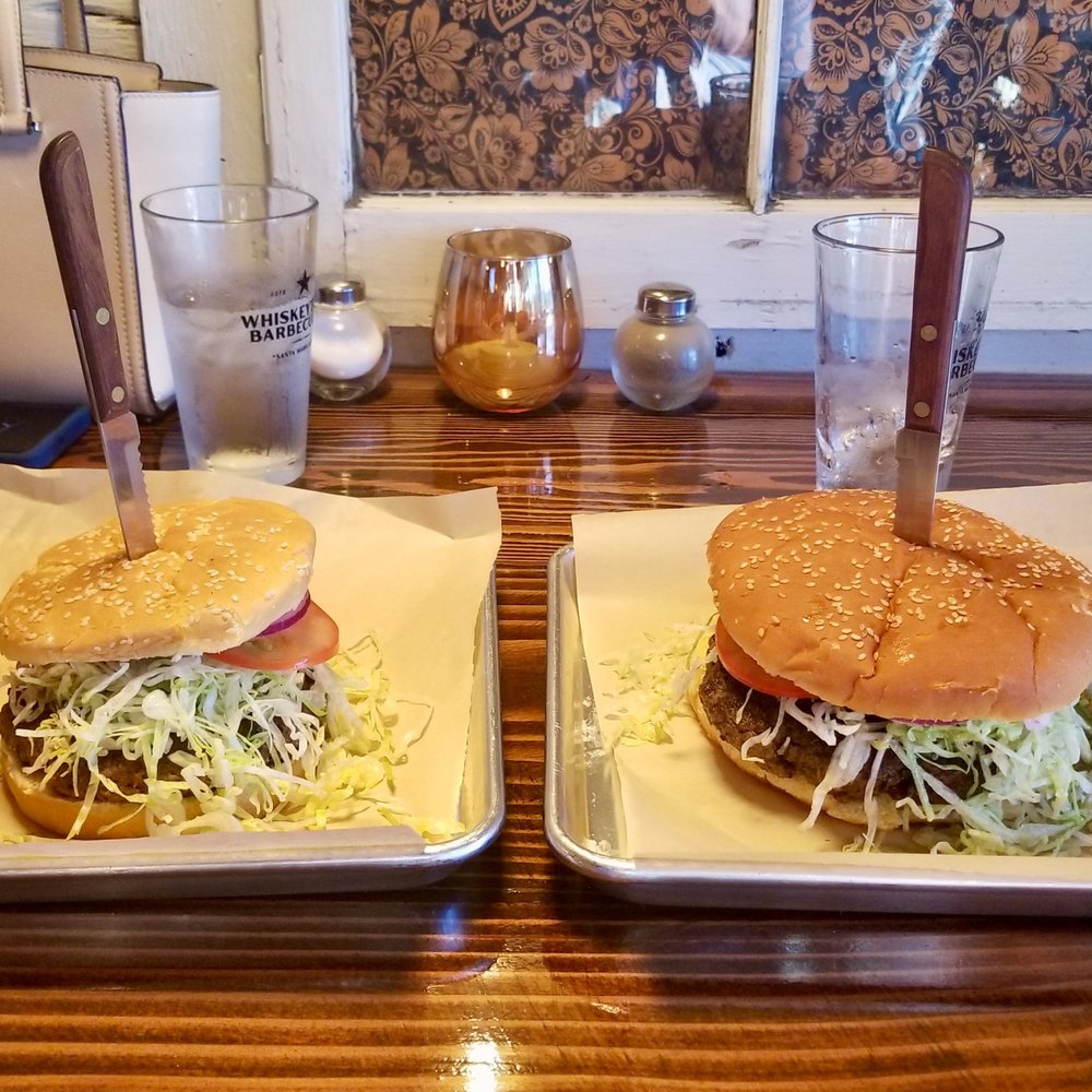 Whiskeytown Barbecue Co - Small 12 oz burger on the left, big 1.1 pound burger on the right. The bigger burger gets a different bun. Sides are small. - Barbeque Near Me - Redding, California Whiskeytown Barbecue Co - Small 12 oz burger on the left, big 1.1 pound burger on the right. The bigger burger gets a different bun. Sides are small. - Barbeque Near Me - Redding, California