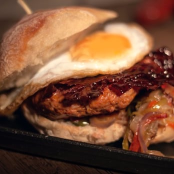 Lobos Meat and Tapas - LOBO BUN. Marinated pork patty with onion, peppers, candy bacon topped with a fried egg - Tapas/Small Plates Near Me - London, XGL