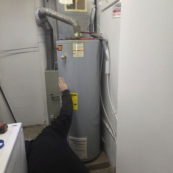 Riley-Armstrong Plumbing & Heating - My new water heater in a tight spot. Just made it past the washing machine. I can't wait! (That's Jim down there fine tuning the height). - Plumbing Near Me - Fort Dodge, Iowa Riley-Armstrong Plumbing & Heating - My new water heater in a tight spot. Just made it past the washing machine. I can't wait! (That's Jim down there fine tuning the height). - Plumbing Near Me - Fort Dodge, Iowa