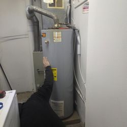 Riley-Armstrong Plumbing & Heating - My new water heater in a tight spot. Just made it past the washing machine. I can't wait! (That's Jim down there fine tuning the height).