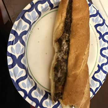 Capriotti's Sandwich Shop - Wagyu large sub. With hot and sweet peppers. This is ONLY half!! So delicious!! - A beef sub sandwich with hot and sweet peppers on a paper plate with a blue and white pattern. - Sandwiches Near Me - Mesa, Arizona