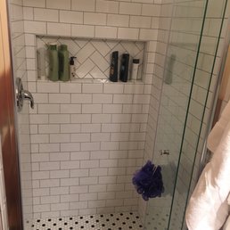 Completely reconstructed master shower with a cut out shelf, beautiful tiles and a butterfly folding door to fit the small space.