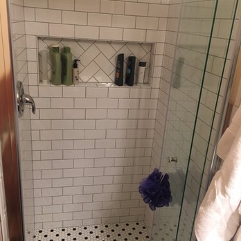 ISC Remodeling - Completely reconstructed master shower with a cut out shelf, beautiful tiles and a butterfly folding door to fit the small space. - General Contractors Near Me - Birdsboro, Pennsylvania