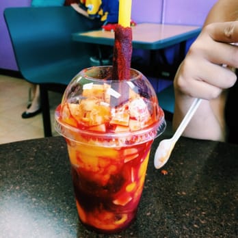 Antojitos Majicos - a person eating a drink - Desserts Near Me - Chicago, Illinois