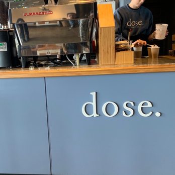 Dose - a man standing at a counter in a coffee shop - Coffee & Tea Near Me - Nashville, Tennessee