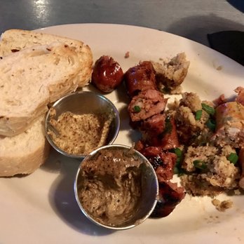 Bon Temps Grill - The sausage and boudin board appetizer; the sausages are served whole (we cut them up to share); this is about half eaten - Cajun/Creole Near Me - Lafayette, Louisiana Bon Temps Grill - The sausage and boudin board appetizer; the sausages are served whole (we cut them up to share); this is about half eaten - Cajun/Creole Near Me - Lafayette, Louisiana