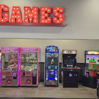 Mountain Mike's Pizza - Game area - Several arcade game machines are lined up against a wall in an entertainment area, with a prominent illuminated 'GAMES' sign above. - Chicken Wings Near Me - Greenfield, Wisconsin