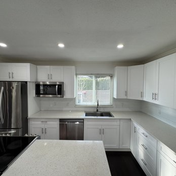 Renotherapy Construction - Full kitchen renovation including installation of new cabinets, a new island, appliances, and backsplash tiling. - General Contractors Near Me
