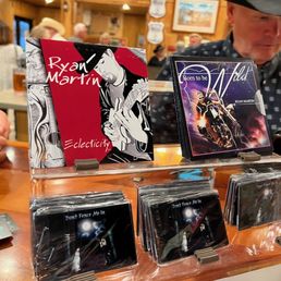 a man looking at cds a man looking at cds