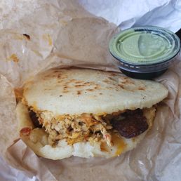 Chicken arepa with sweet plantains, cheddar cheese and cilantro avocado sauce. Chicken arepa with sweet plantains, cheddar cheese and cilantro avocado sauce.