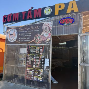 Com Tam Pa Phi - Vietnamese cuisine food truck in Austin, TX, with a menu of traditional dishes, outdoor picnic tables, and an open sign. - Food Trucks Near Me - Austin, Texas