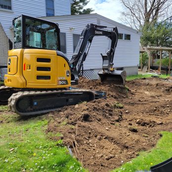 Topping Landscaping - an excavator digging a hole - Landscaping Near Me - Billerica, Massachusetts