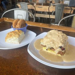 Filthy animal biscuit with gravy, bacon, pimento cheese, egg, and fried chicken.  Regular biscuit with three fried green tomatoes.