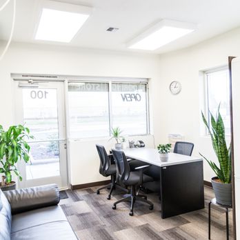 NW Surfaces - an office with a couch and a table - Flooring Near Me - Vancouver, Washington