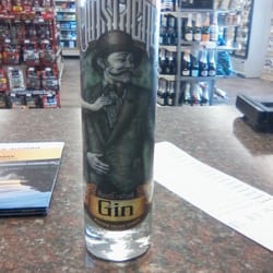 Bridge Street Wine and Spirts - They have Ginstache Gin from Rusted Crow Spirits w/ bottle art by artist Josh Skeel & featuring Model Liz La Point.