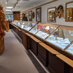 The Gold Shop - Large jewelry display case along far wall of store.