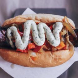 Bangers & Brews - Redmond - Smoked Hot Andouille with Grilled Onions, Sweet Peppers & Chimichurri Mayo Sauce.