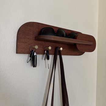 Elite Home Solutions - a purse and sunglasses hanging on a coat rack - Plumbing Near Me Elite Home Solutions - a purse and sunglasses hanging on a coat rack - Plumbing Near Me