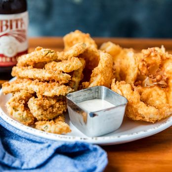 Orleans Seafood Kitchen - a plate of fried onion rings and a bottle of beer - Seafood Near Me - Fulshear, Texas Orleans Seafood Kitchen - a plate of fried onion rings and a bottle of beer - Seafood Near Me - Fulshear, Texas