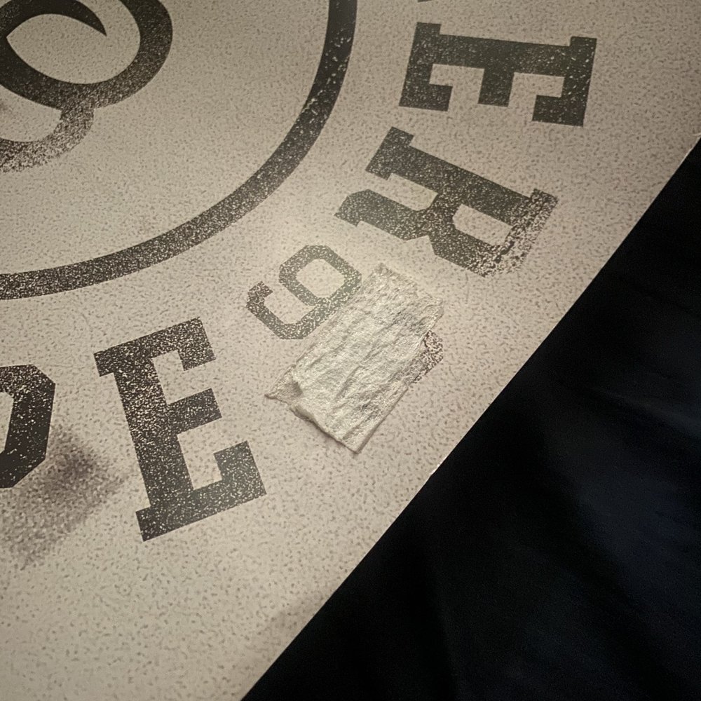tape stuck to the front of the poster