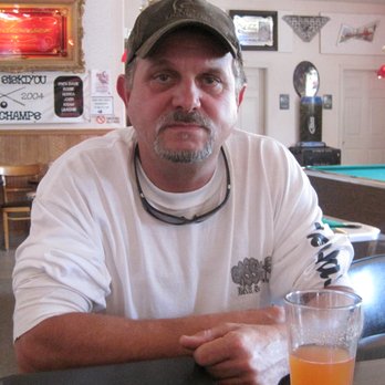 Papa's Place - a man sitting at a table with a beer - Pubs Near Me - Weed, California