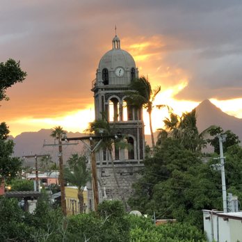 Hotel Posada De Las Flores - Sunset view of the mission from the rooftop lounge. - Hotels Near Me - Loreto, BCS