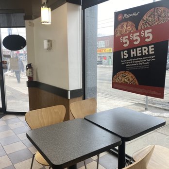 Pizza Hut - a table and chairs in front of a window - Pizza Near Me - Etobicoke, Ontario Pizza Hut - a table and chairs in front of a window - Pizza Near Me - Etobicoke, Ontario